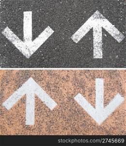 set of directional arrow signs on the asphalt road