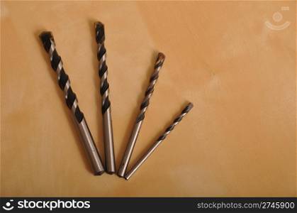 set of drill bits on wooden background
