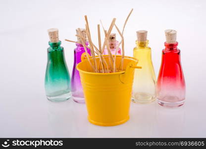 Set of Empty little transparent bottles by the side of a yellow bucket