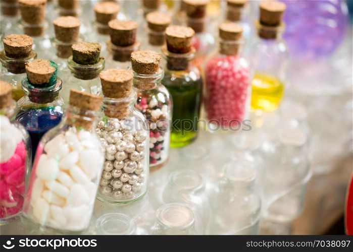 Set of Empty small transparent bottles filled with beads