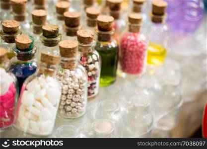 Set of Empty small transparent bottles filled with beads