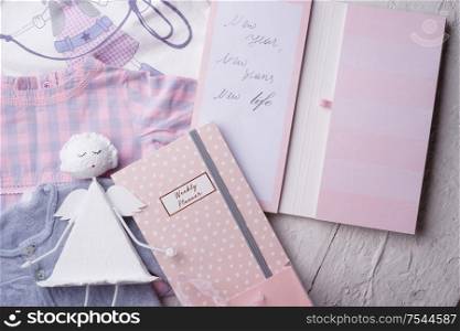 set of expectations and plans of woman at new year with child clothes and angel. concept shot