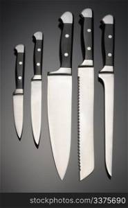 Set of forged steel kitchen knife on a black background