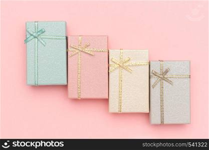 Set of gift boxes of pastel colors on pink background, Top view.. Set of gift boxes of pastel colors on pink background, Top view