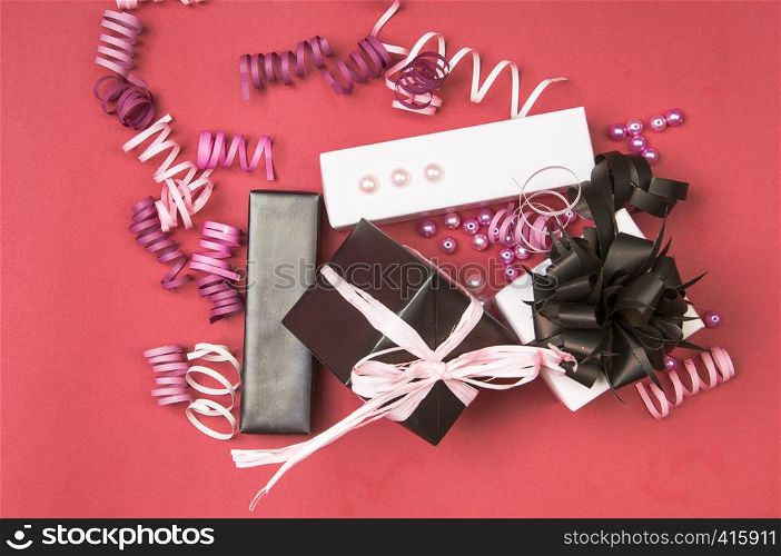 Set of gift boxes with bows, beads and ribbons on a colored background