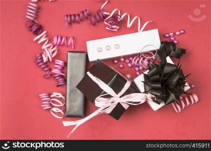 Set of gift boxes with bows, beads and ribbons on a colored background