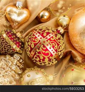 set of golden christmas balls decoration on soft silk background with sparkles. golden christmas ball