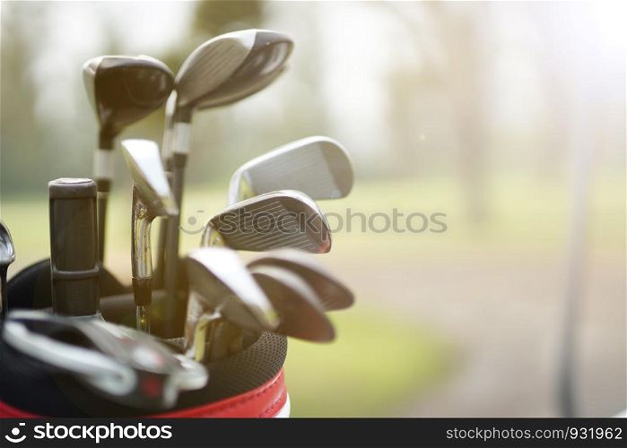 set of golf clubs in a golf bag with fairway background