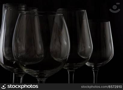 Set of high wine glasses on black close up. Wine glasses on black
