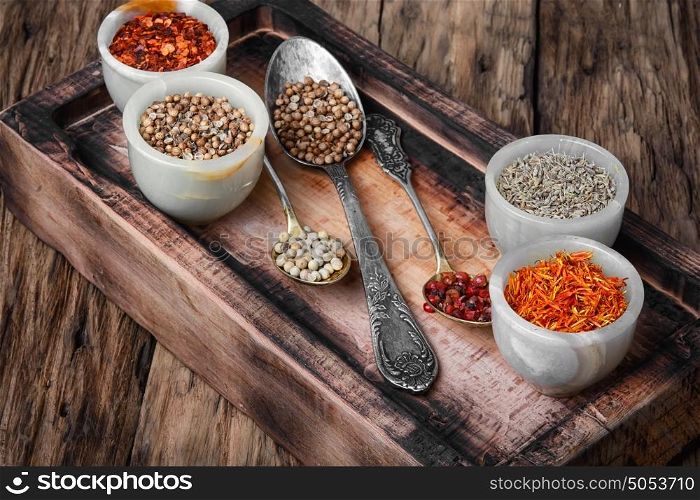 set of Indian spices peppers. spice of hot peppers peas on the kitchen blackboard on vintage background