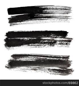 Set of ink black brush strokes isolated on the white background