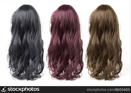 set of long curly wigs on a white background
