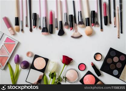Set of makeup brushes and other accessories. Lipstick, mascara, nail polish, eyeshadow, powder, eyelash and foundation. Products for makeup on white background, top view.