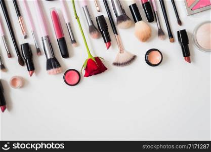 Set of makeup brushes and other accessories. Lipstick, mascara, nail polish, eyeshadow, powder, eyelash and foundation. Products for makeup on white background, top view.