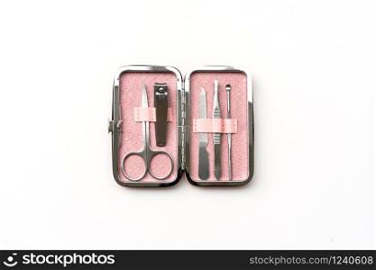 Set of manicure instruments and tools in the pink case isolated on white background, top view