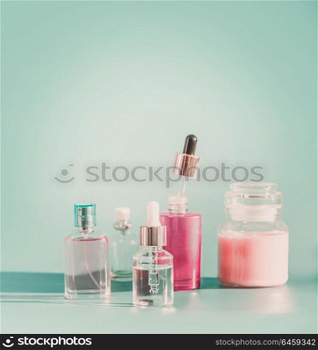 Set of modern facial skin care cosmetics at blue background Product bottles with dropper and pipette, mist spray , serum and moisturizing in glass jar. Front view. Branding mock-up