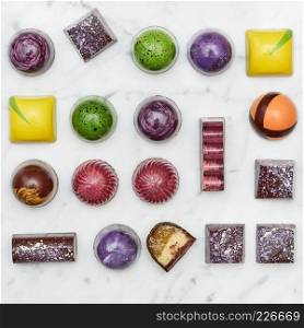 Set of multi-colored sweets tasty, isolated on a white marble background. Set of multi-colored sweets tasty