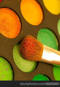 Set of Multicolored orange-yellow Eyeshadows with Brush, closeup