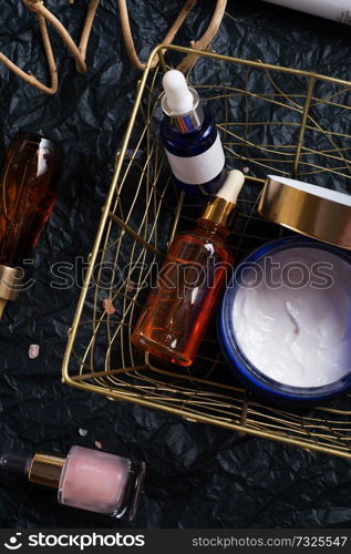 set of nature precious oils and  care cosmetics on black background .