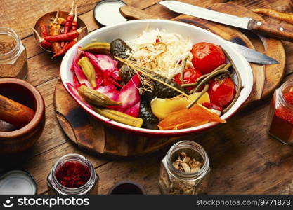 Set of pickles from tomato, sauerkraut, okra, cucumbers and cowpea. Pickles vegetable on wooden table. Homemade pickles, salty vegetables