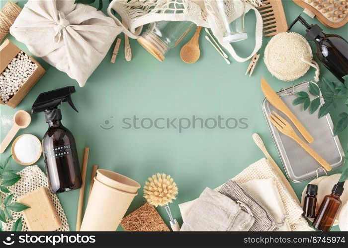 Set of reusable eco friendly products . Zero waste concept. Eco natural paper cups, bamboo cutlery, natural cleaning products on light blue background, flat lay. Plastic free sustainable lifestyle concept copy space border frame