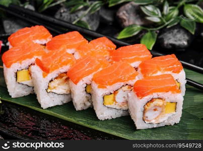 Set of salmon sushi rolls on stone plate