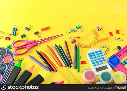 Set of school supplies on yellow background. Pencils, markers, pens, calculator, paperclips, scissors, paint from top view. Free space for text.