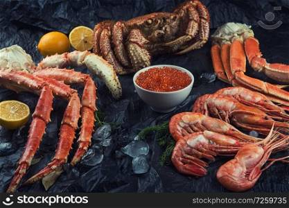 Set of seafood: red and black caviar, limb of hairy crab, limb of snow crab, far eastern kamchatka crab. Set of fresh seafood