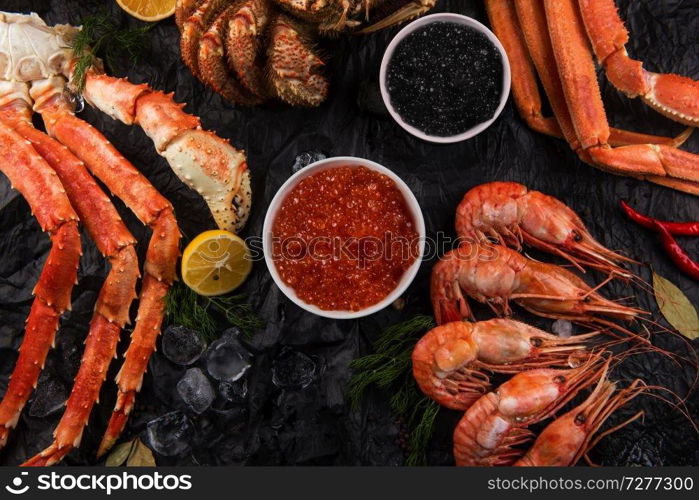 Set of seafood: red and black caviar, limb of hairy crab, limb of snow crab, far eastern kamchatka crab. Set of fresh seafood