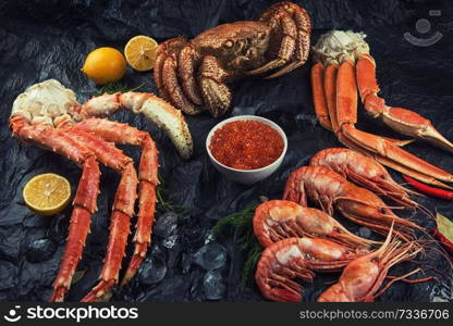 Set of seafood: red and black caviar, limb of hairy crab, limb of snow crab, far eastern kamchatka crab. Set of fresh seafood