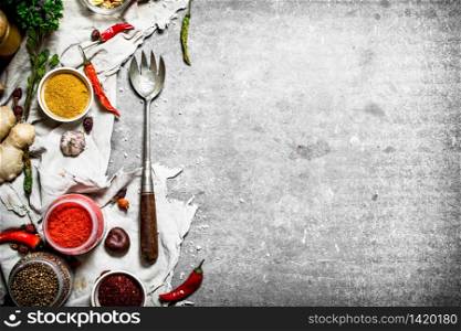 Set of spices and herbs on an old fabric. On a stone background.. Set of spices and herbs