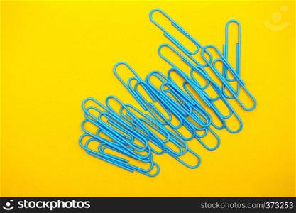 set of stationery - blue clips on a yellow background