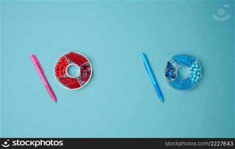 set of stationery objects  pen, paper clip, buttons and clip on a blue background. View from above