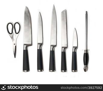 Set of steel kitchen knives, isolated on white with soft shadows. Includes carving, paring, and utility knives.