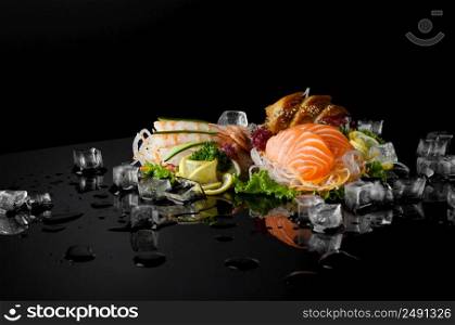 set of sushi with pieces of melting ice on a black background with reflection. sushi on black background