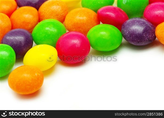 Set of sweet dragees of different color on white background