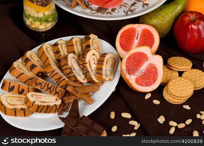 Set of sweet fruit and cake on a restaurant table background