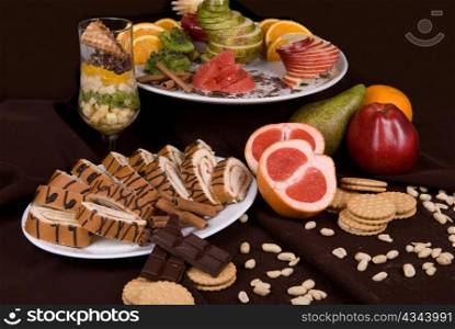 Set of sweet fruit and cake on a restaurant table background