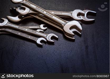 Set of the stainless steel wrench on dark background