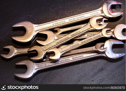 Set of the stainless steel wrench on dark background