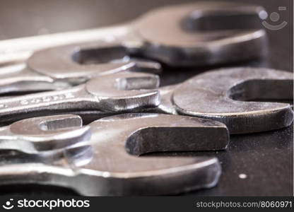 Set of the stainless steel wrench on dark background