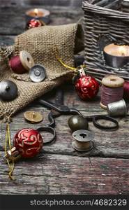 set of threads and buttons. Set of sewing tools on a wooden table and Christmas tree decorations
