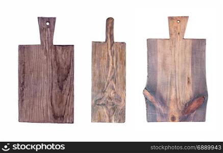 Set of three old rough dark wooden cutting boards isolated on a white background