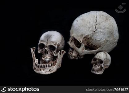 Set of tiny skulls on black background