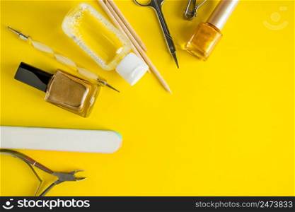 Set of tools for manicure and nail care on a yellow background. Place for text.. Set of tools for manicure and nail care on a yellow background.