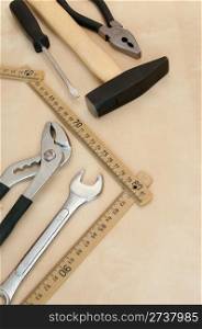 Set of Tools(Hammer, Screwdriver, Pliers, Spanner, Folding Rule) on Wooden Background With Copyspace