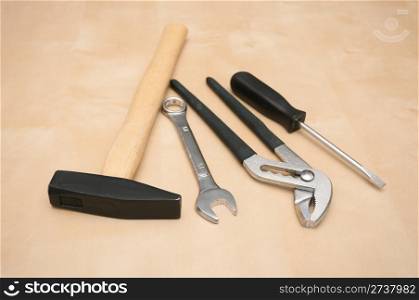 Set of Tools(Hammer, Screwdriver, Pliers, Spanner) on Wooden Background With Copyspace - Shallow Depth of Field