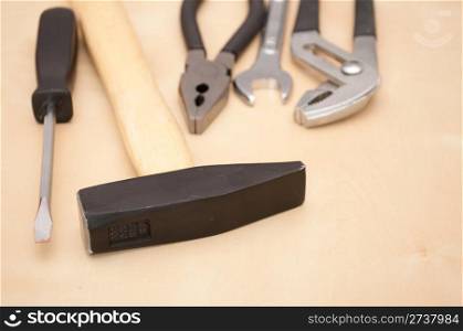 Set of Tools(Hammer, Screwdriver, Pliers, Spanner) on Wooden Background With Copyspace - Shallow Depth of Field