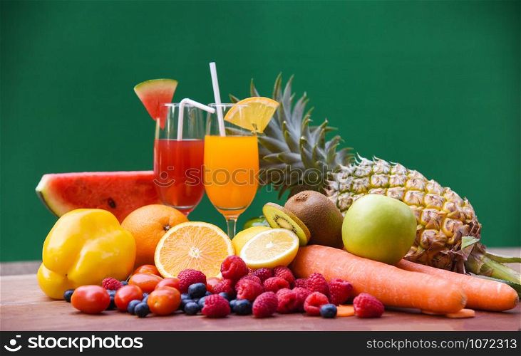 Set of tropical fruits colorful and fresh summer juice glass healthy foods / Many ripe fruit mixed on green background