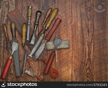 set of vintage chisels and sharpening stones, strop over wooden bench, space for your text